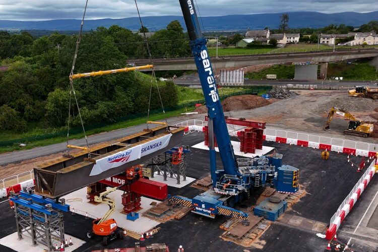 The first of five beams is set on tressels