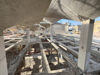 The asymmetrical hyperbolic paraboloid concrete roof structures give the building the feeling of a traditional covered market